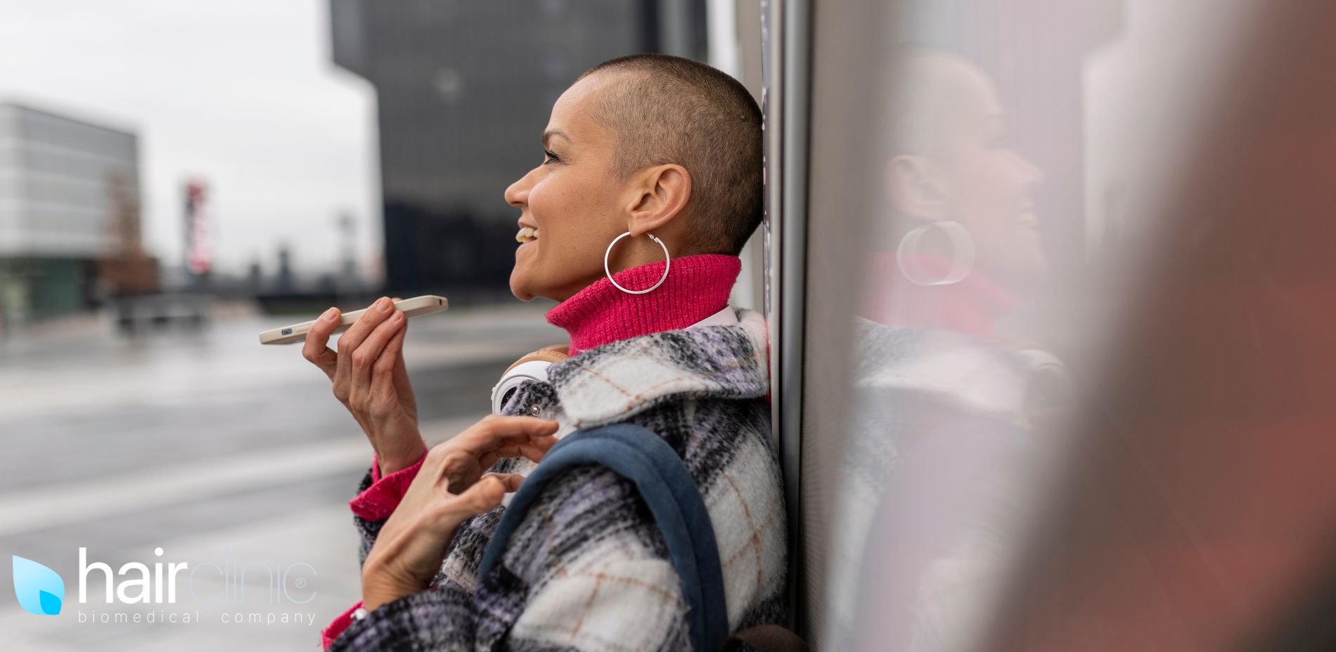 bald woman speaking on the phone
